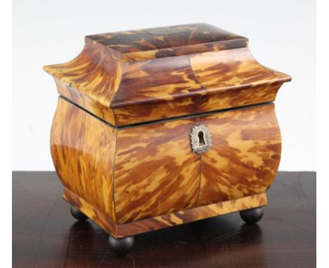 A 19th century bombe shape tortoiseshell tea caddy, the shaped rectangular lid revealing a two division interior, one compart
