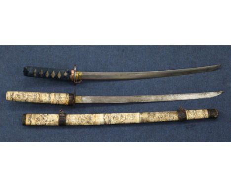 An early 20th century Japanese bone wakizashi, decorated all over with traditional figural scenes, 32in., together with anoth