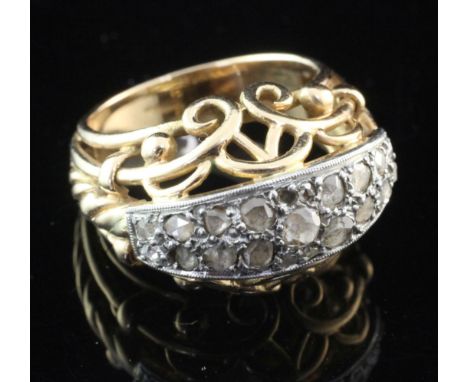 A 1950's/1960's continental gold and rose cut diamond set dress ring, with pierced scroll setting, size M.