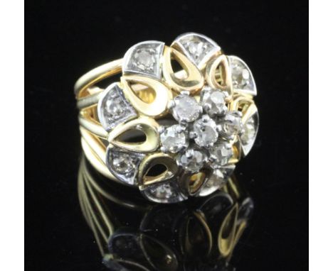 A 1960's? French 18ct gold and diamond set dress ring, of raised pierced flower head design, size H.