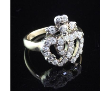 A late Victorian gold and diamond set entwined twin hearts ring, set with old cut stones, size L.