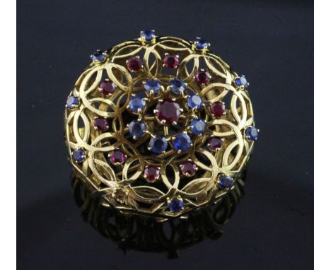 A French 18ct gold, ruby and sapphire set clip brooch by Mellerio, Paris, of raised, pierced circular form, signed and number