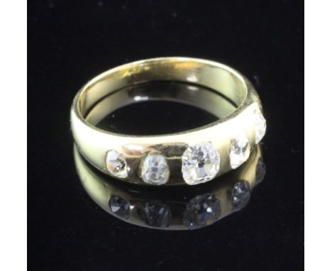 A late Victorian gold and gypsy set five stone diamond ring, set with five graduated old mine cut stones, size P.