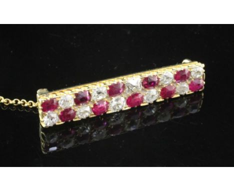 A 1940's/1950's gold, ruby and diamond bar brooch, set with twenty alternating old cut rubies and diamonds, 1.25in.