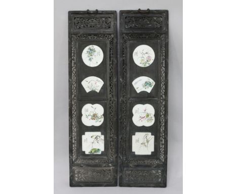 A pair of Chinese hardwood and porcelain mounted panels, each inset with four shaped famille rose porcelain plaques painted w