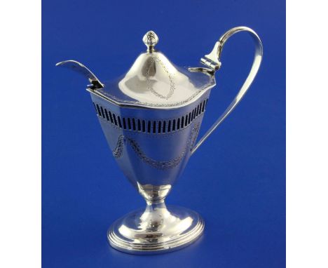 A late Victorian Adams style silver mustard pot, with pierced border, blue glass liner and engraved with swags, Nathan & Haye