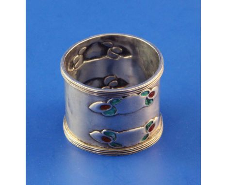 An Edwardian Art Nouveau Liberty & Co Cymric silver and enamel napkin ring, embossed with four two colour enamel stylised mot