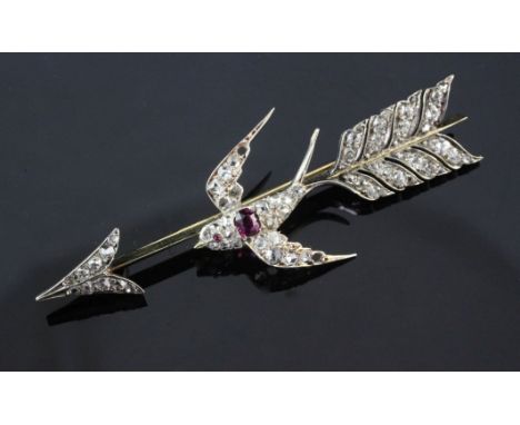 A mid 20th century gold, ruby and diamond set swallow and arrow brooch, set with old and rose cut stones, lacking two small d
