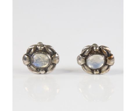 A Vintage Danish pair of clip earrings, stylised sterling silver set with foiled back blue cabochon moonstones, earring width