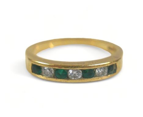 A seven-stone emerald and diamond ring, comprising three diamonds and four emeralds on 750 / 18ct gold band, size J, each sto