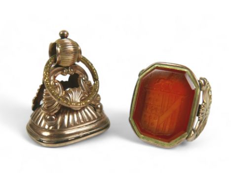 Two Georgian yellow metal fob seals, comprising a Carnelian fob converted into a gents ring, impressed with a shield crest, s