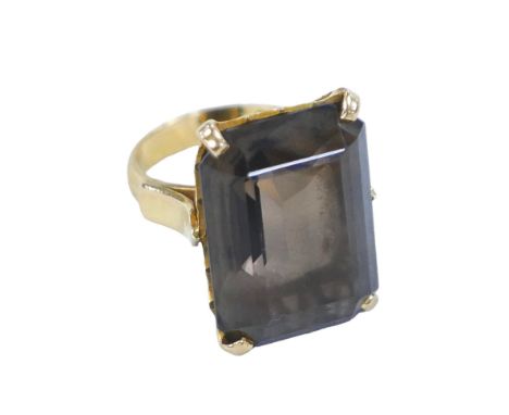 An 18ct gold smoky quartz ring, the rectangular cut stone 16 by 22mm, size n, 11.9g. 