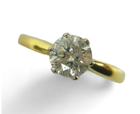 An 18ct yellow and white gold, diamond solitaire ring, the brilliant cut stone, 6.4 by 4.0mm, approximately 1.0ct, in a six c