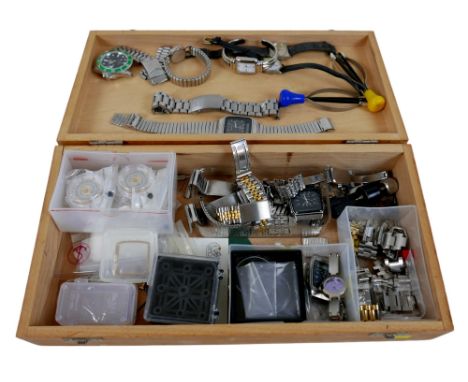 A collection of assorted watch repairing tools, straps, movements, and parts. 