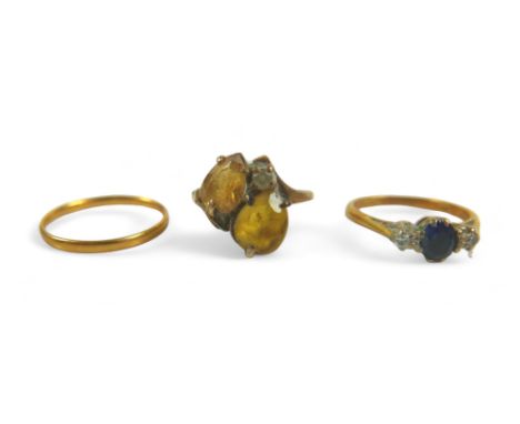 A group of three gold rings, including a 9ct gold ring set with two yellow pear-shaped stones, 2.9g, size L, a diamond and sa