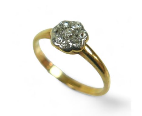 An 18ct gold and diamond flower head ring, size M/N, 2.3g. 