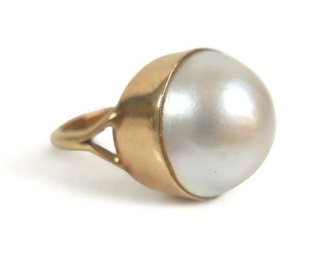 A 9ct gold ring set with a large cabochon pearl, approximately 15 mm diameter, size K, 6.9g. 