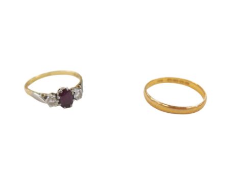 A 22ct gold ring, size N, 2.2g, and an 18ct gold ruby diamond dress ring, the oval cut ruby 4 by 6mm, flanked by single round