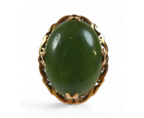 A yellow gold jade ring, size N, head size 24 by 11 by 19mm, 5.9g. 
