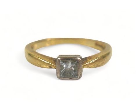 A diamond solitaire ring, the princess cut stone on gold band, size J. 