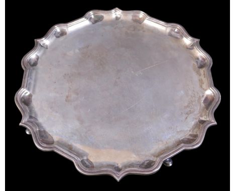 A Garrard & Co Ltd silver tray, on four pad feet with shaped pie crust edge, Sheffield 1967, 36cm diameter, 38.15toz. 