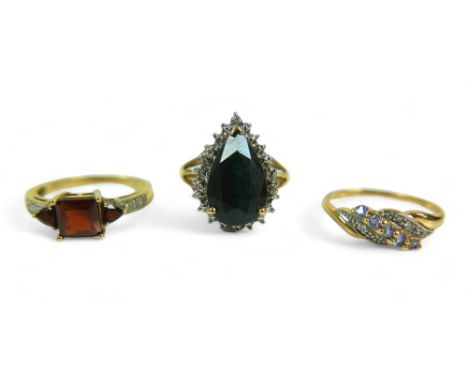 A group of of three 9ct gold dress rings, comprising a pear shaped blue stone ring, 18.57mm at widest point, size P, a red st