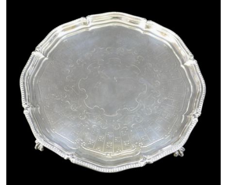 A George V silver tray, with decorative scalloped edge, engraved centre, raised on three ball and claw feet, Linley & Hodd (R