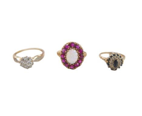 Three 9ct gold dress rings, comprising an opal and ruby daisy ring, the central oval opal 8 by 6mm, size P/Q, 3.3g, a blue an