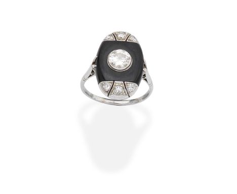 ONYX AND DIAMOND RINGThe oval-shaped panel with a central onyx plaque set with a brilliant-cut diamond, each end millegrain s
