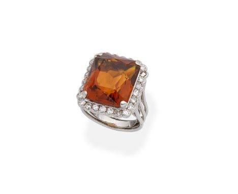 CITRINE AND DIAMOND RINGThe step-cut citrine set within a single-cut diamond surround, one diamond deficient,  ring size appr