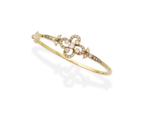 DIAMOND BANGLE, LATE 19TH CENTURYSet to the front with an openwork quatrefoil motif, of cushion-shaped, old brilliant and ros
