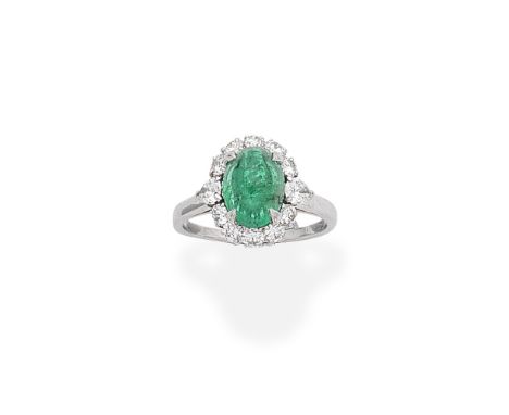 BULGARI: EMERALD AND DIAMOND CLUSTER RINGThe oval cabochon emerald within a surround of brilliant and pear-shaped diamonds,  