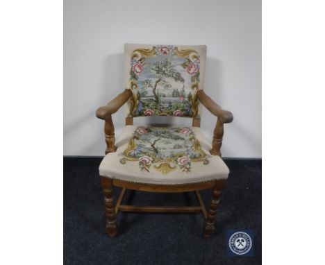 A 20th century oak armchair in floral tapestry fabric 