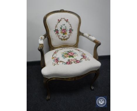 A continental walnut armchair on cabriole legs in tapestry fabric 