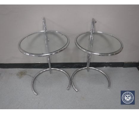 A pair of circular adjustable metal lamp tables 