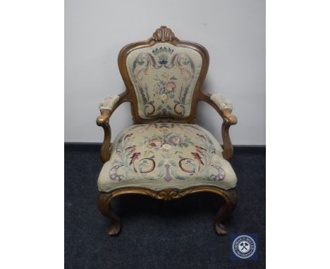 An early 20th century armchair in floral tapestry 