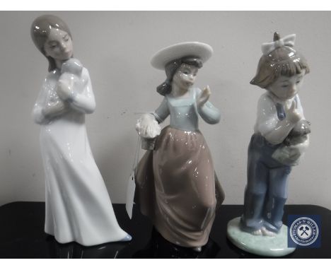 Three Nao figurines ; girl with puppy, girl with doll and basket of flowers. (3)