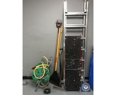 An aluminium multi function ladder with platform, hose pipe on reel and quantity of garden tools 