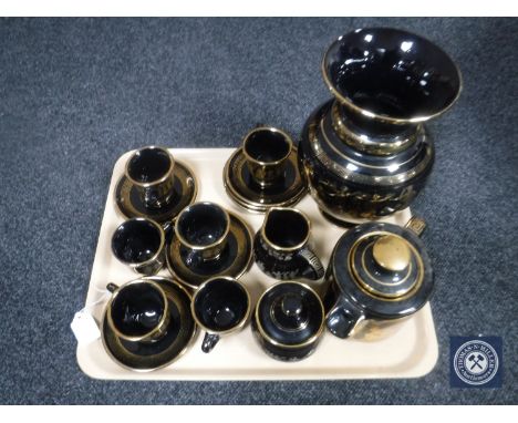 A tray of sixteen piece black and gilt Greek tea service together with matching vase 