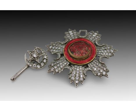 An Islamic Ottoman White Metal Medal Brooch with Red Enamel and Islamic Calligraphy: Approximately 7.3cm in width. 