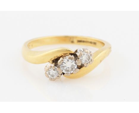 SOLD WITHOUT BUYERS PREMIUM AND VAT. An 18ct yellow gold diamond three stone ring, set with three graduated round brilliant c