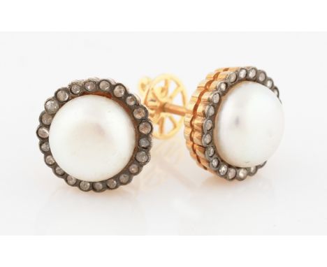 A pair of yellow metal mabe pearl and diamond stud earrings, each set centrally with a mabe pearl surrounded by a border of r