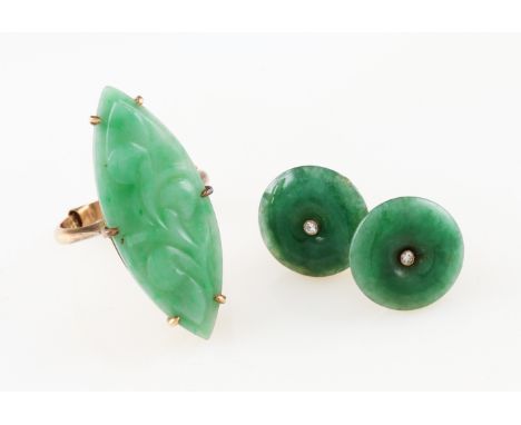 A pair of yellow metal jade and diamond stud earrings, the carved circular piece of jade set centrally with an eight cut diam