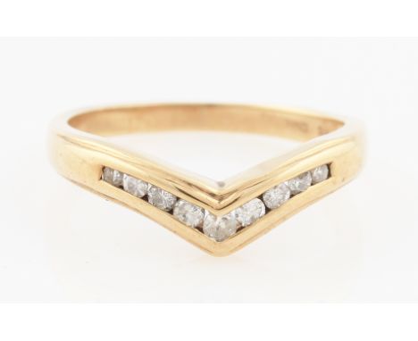 SOLD WITHOUT BUYERS PREMIUM AND VAT. A 9ct yellow gold diamond wishbone ring, channel set with nine round brilliant cut diamo