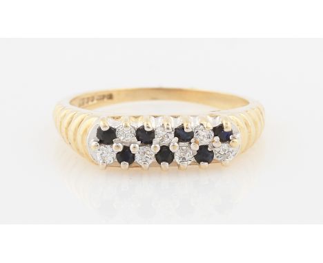 SOLD WITHOUT BUYERS PREMIUM AND VAT. A 9ct yellow gold sapphire and colourless stone ring, featuring two rows of alternating 