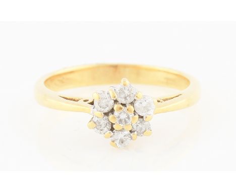 SOLD WITHOUT BUYERS PREMIUM AND VAT. An 18ct yellow gold diamond cluster ring of flower head design, set with seven round bri