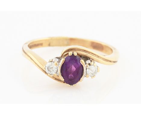 SOLD WITHOUT BUYERS PREMIUM AND VAT. A 9ct yellow gold amethyst and diamond three stone ring, set with a central oval cut ame