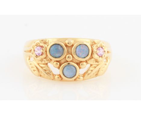 SOLD WITHOUT BUYERS PREMIUM AND VAT. A 14ct yellow gold synthetic opal and pink topaz ring, set in an open metalwork foliage 