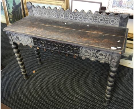 An early 20th Century carved oak side / console table with single drawer and patterned band.