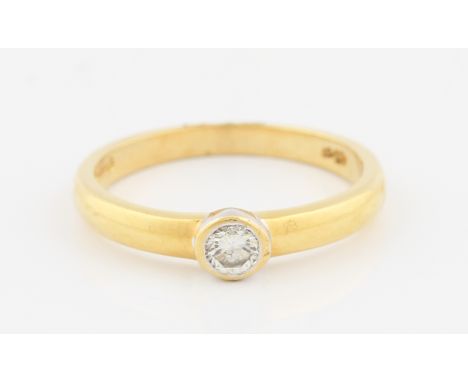 SOLD WITHOUT BUYERS PREMIUM AND VAT. An 18ct yellow gold diamond solitaire ring, rub over set with a round brilliant cut diam